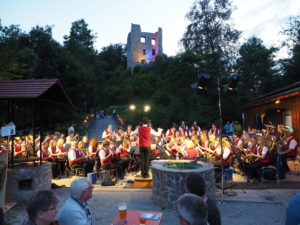 Musikkapelle mit beleuchteter Ruine